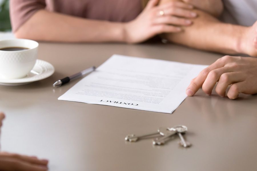 closeup-contract-table-couple-taking-mortgage-loan-min